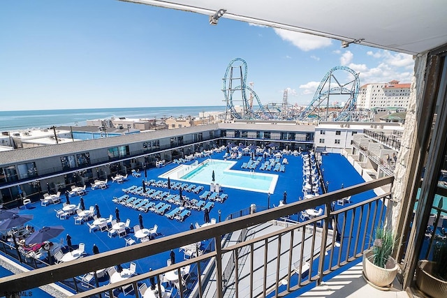 view of swimming pool with a water view