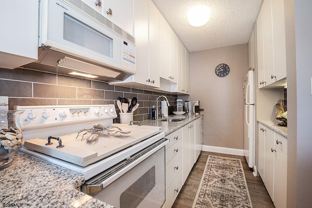 kitchen with white appliances and white cabinets