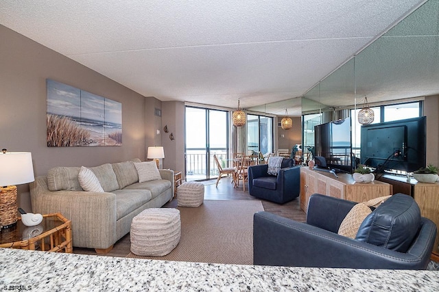 living room with floor to ceiling windows and a textured ceiling