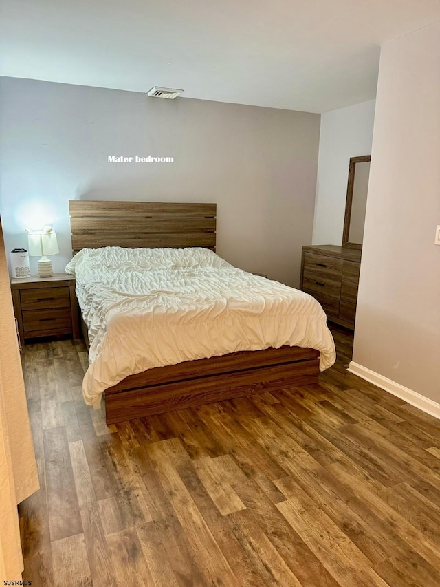 bedroom with hardwood / wood-style floors