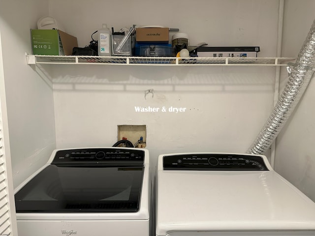 clothes washing area with washing machine and clothes dryer