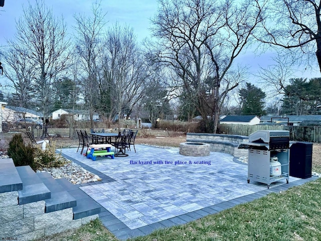 view of patio featuring an outdoor fire pit and a grill