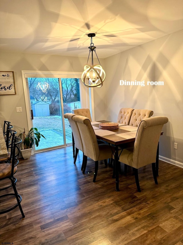 dining space with dark wood-type flooring and a chandelier