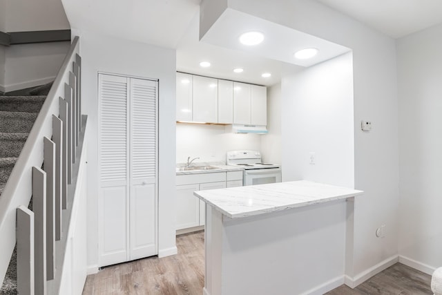 kitchen with light hardwood / wood-style floors, sink, white cabinets, and white range with electric cooktop