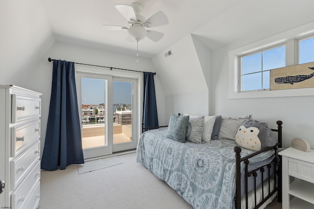 carpeted bedroom with ceiling fan, lofted ceiling, and access to outside