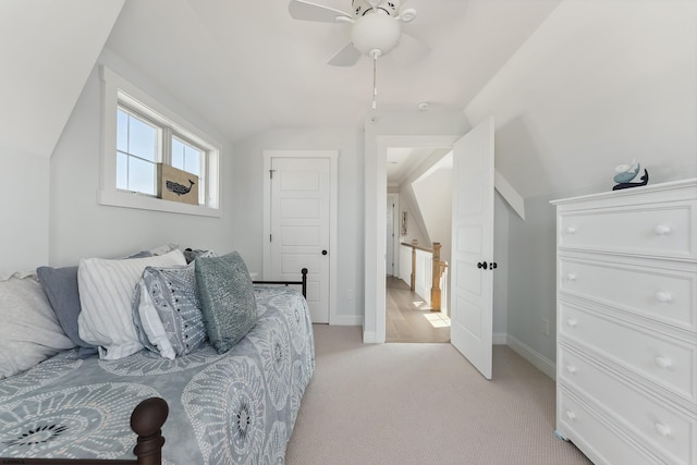 bedroom featuring ceiling fan, light colored carpet, and vaulted ceiling