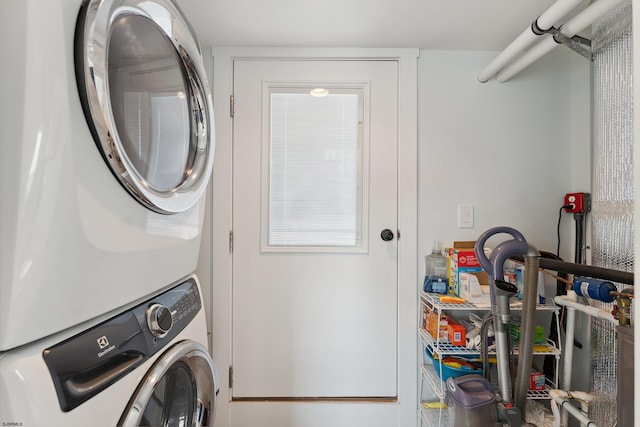 clothes washing area with stacked washer / drying machine