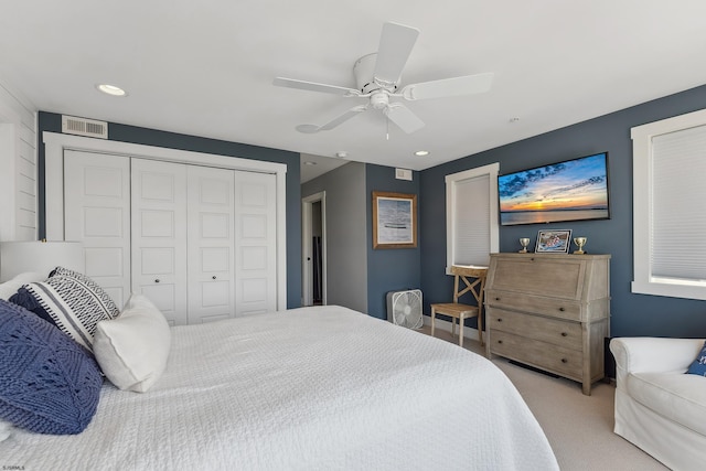 carpeted bedroom featuring ceiling fan and a closet