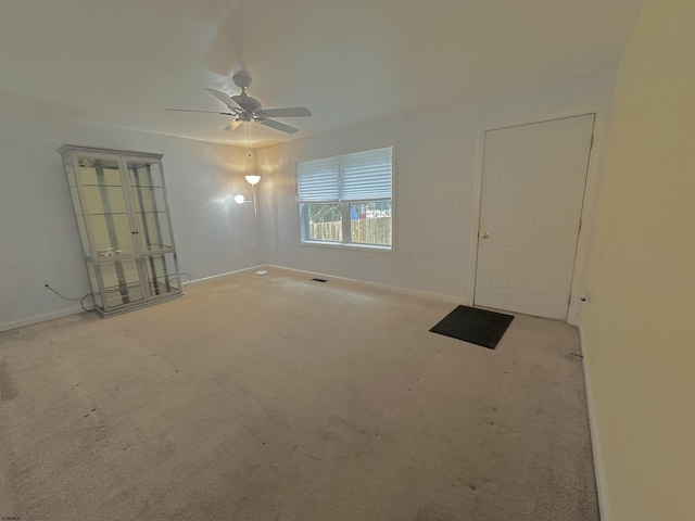 carpeted empty room with ceiling fan