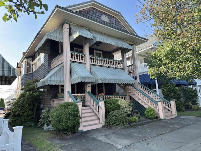 exterior space with a porch and a balcony