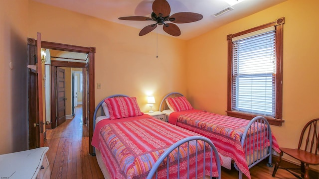 bedroom with ceiling fan and dark hardwood / wood-style floors