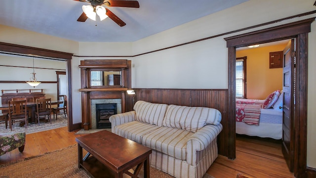 living room featuring ceiling fan and hardwood / wood-style flooring