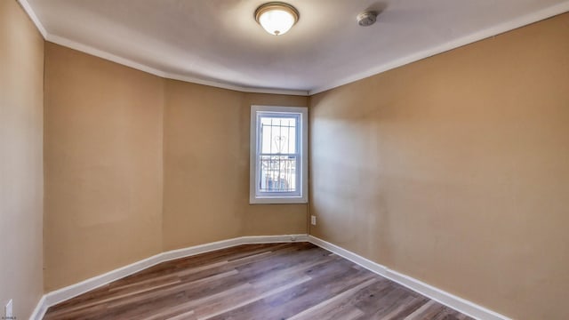 unfurnished room featuring wood-type flooring and crown molding