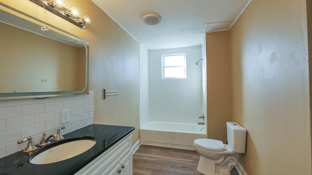 full bathroom featuring tiled shower / bath combo, vanity, tasteful backsplash, toilet, and ornamental molding