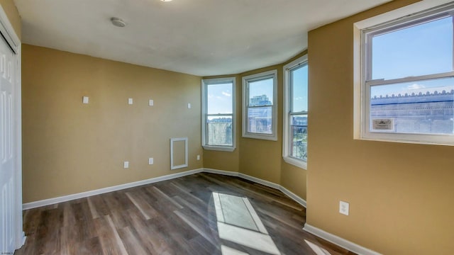 empty room featuring dark wood-type flooring