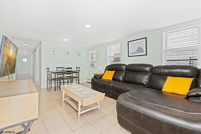 tiled living room with a baseboard heating unit