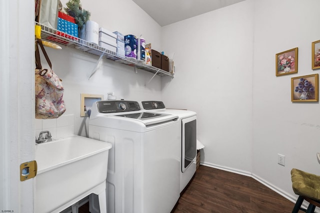 laundry room featuring washer and clothes dryer, dark hardwood / wood-style floors, and sink