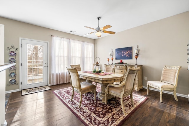 dining room with dark wood-type flooring, a healthy amount of sunlight, and ceiling fan