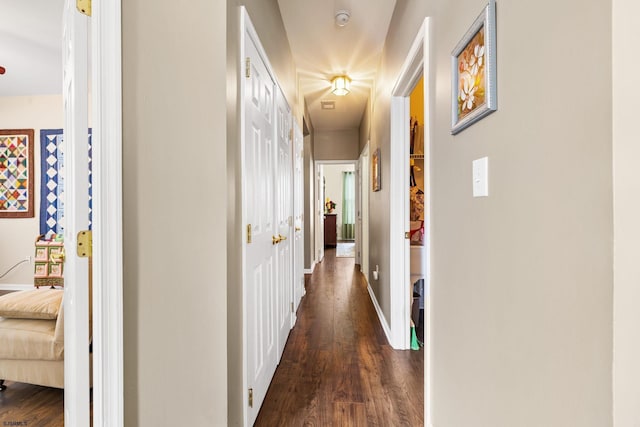 hallway with dark hardwood / wood-style flooring