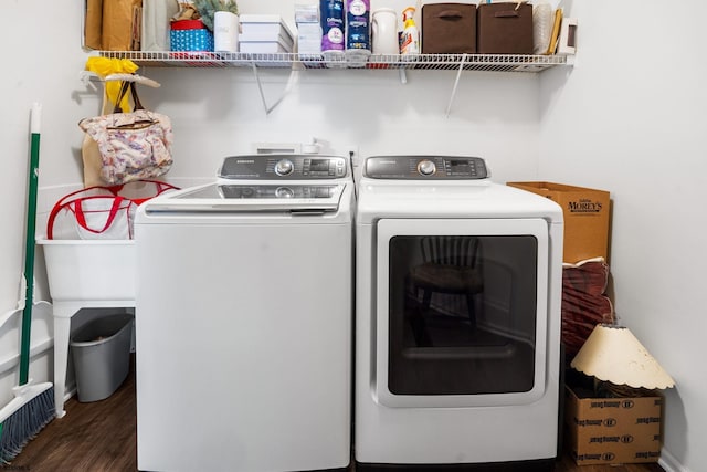 laundry area with dark hardwood / wood-style flooring and independent washer and dryer