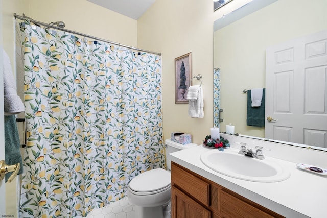 bathroom featuring toilet, vanity, and tile patterned flooring