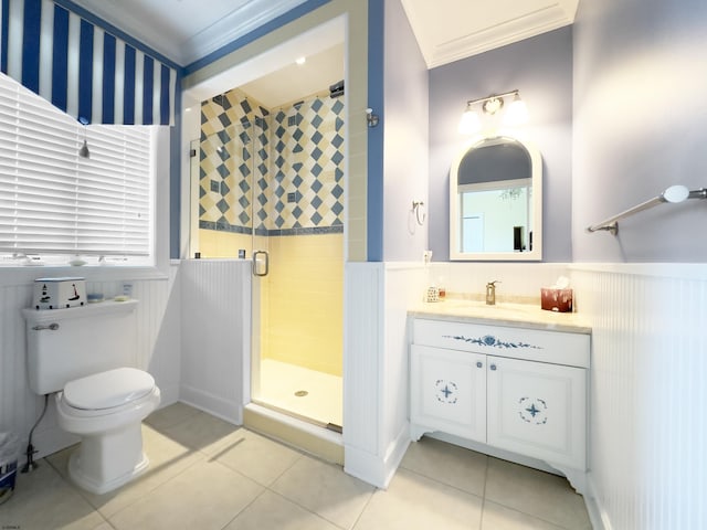 bathroom featuring tile patterned flooring, vanity, toilet, ornamental molding, and a shower with shower door