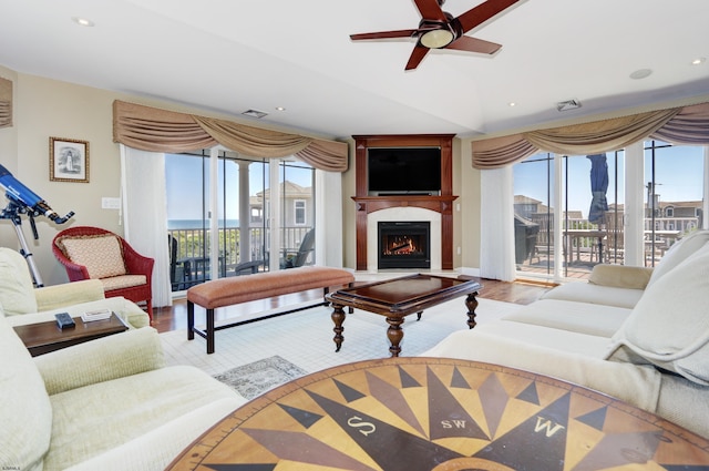 living room featuring ceiling fan and hardwood / wood-style floors