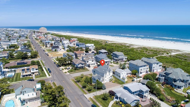 birds eye view of property featuring a beach view and a water view