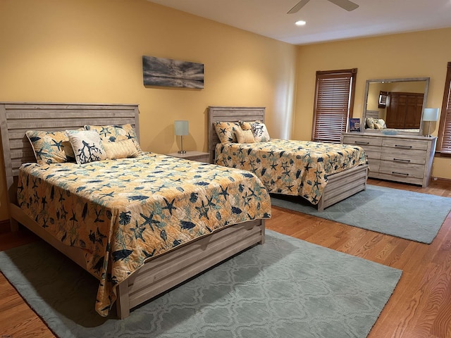 bedroom featuring ceiling fan and light hardwood / wood-style flooring