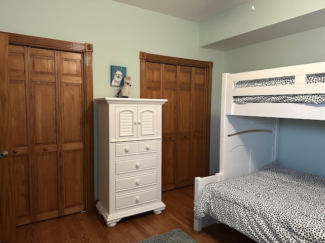 bedroom with dark hardwood / wood-style floors