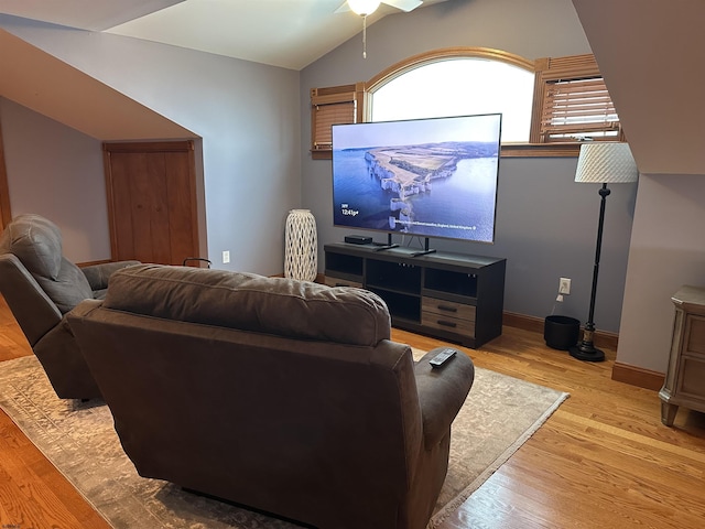 home theater room featuring vaulted ceiling, ceiling fan, and light hardwood / wood-style flooring