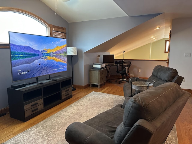 living room featuring vaulted ceiling and light hardwood / wood-style floors