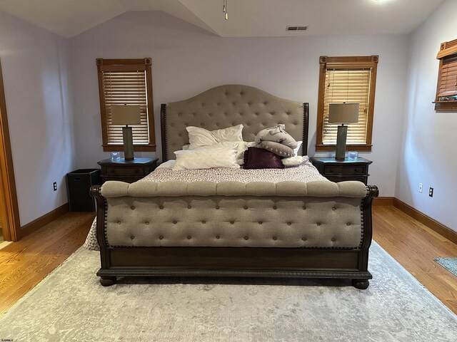 bedroom featuring vaulted ceiling and hardwood / wood-style floors