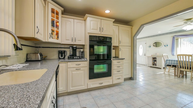 kitchen featuring light tile patterned floors, ceiling fan, backsplash, double oven, and sink