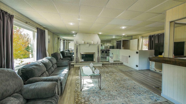 living room with a large fireplace and hardwood / wood-style floors