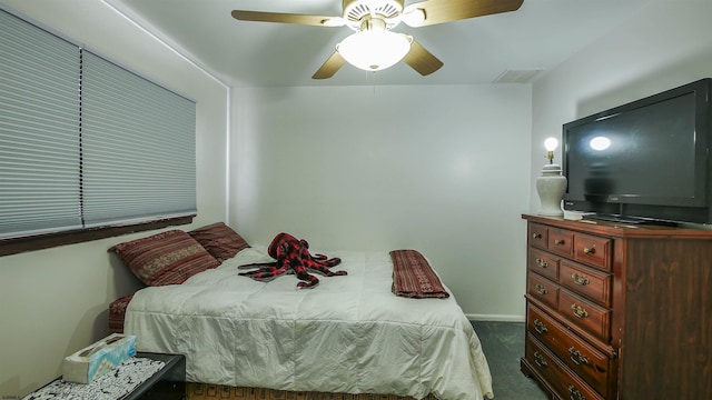 bedroom with ceiling fan and dark colored carpet