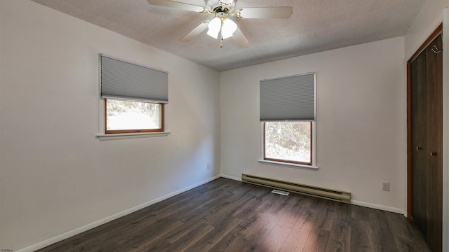 empty room featuring ceiling fan, a baseboard radiator, a textured ceiling, and dark hardwood / wood-style flooring