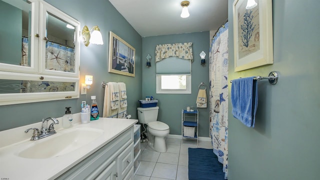 bathroom with toilet, vanity, and tile patterned floors