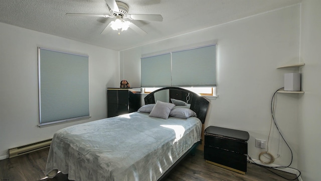 bedroom with ceiling fan, baseboard heating, a textured ceiling, and dark hardwood / wood-style flooring