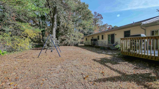 view of yard with a playground and a wooden deck