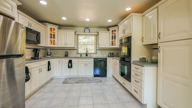 kitchen with black appliances, sink, decorative backsplash, and light tile patterned flooring