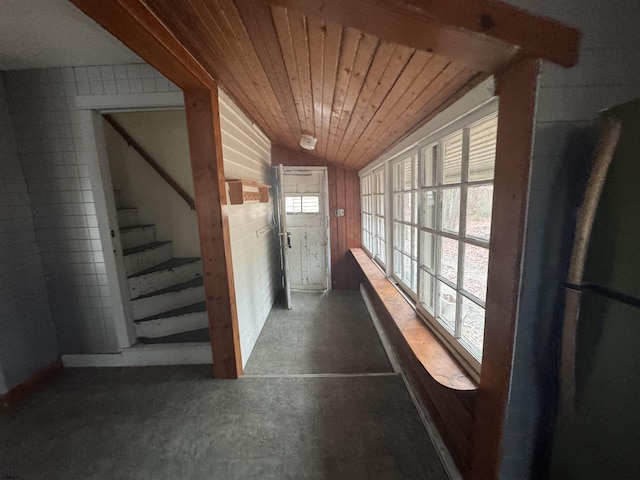 interior space with wooden ceiling, wooden walls, and vaulted ceiling