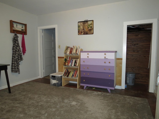 bedroom featuring wood walls