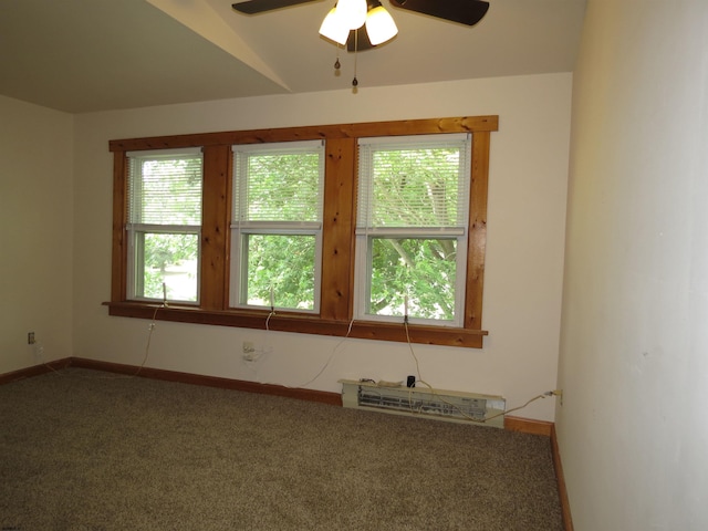 empty room featuring ceiling fan, carpet, vaulted ceiling, and a healthy amount of sunlight