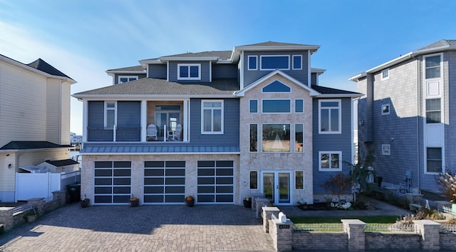 view of front of home with a garage and a balcony