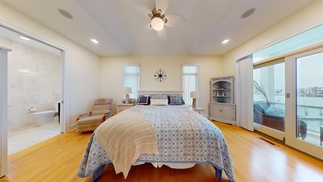 bedroom featuring ceiling fan, access to exterior, ensuite bathroom, and light hardwood / wood-style floors