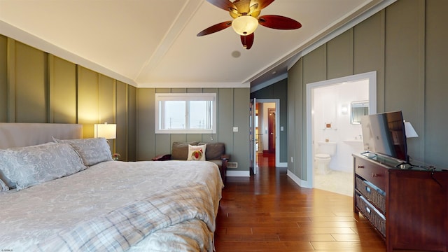 bedroom featuring ceiling fan, lofted ceiling, dark hardwood / wood-style floors, and ensuite bath