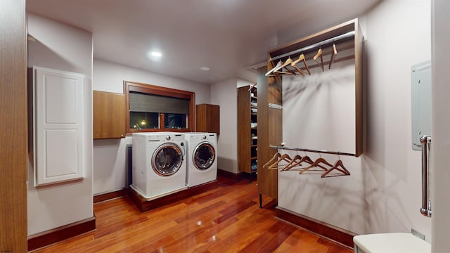 laundry area with light wood-type flooring and separate washer and dryer