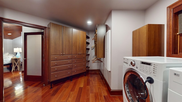 laundry room featuring washer and dryer and hardwood / wood-style flooring