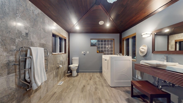 bathroom featuring toilet, wood ceiling, hardwood / wood-style flooring, lofted ceiling, and sink